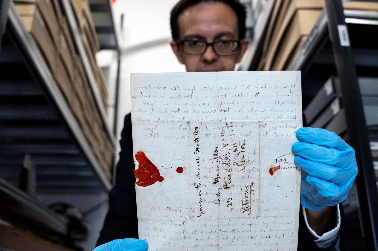 A man holds Nelson's letters